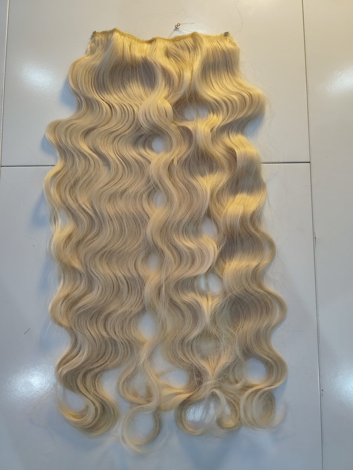 Extension a fascia CODE_MODA in capelli naturali biondo platino con texture ondulata per volume e lunghezza extra